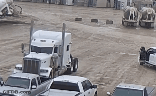 White Semi Truck Parked Next To Row Of White Trucks GIF