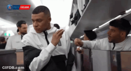White Shirt Man Next To Black Shirt Man On Plane GIF
