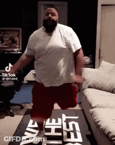 White Shirt Man Red Shorts On One Leg GIF