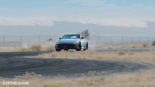 White Sports Car Driving Down Road GIF