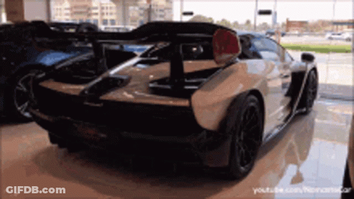 White Sports Car In Showroom GIF