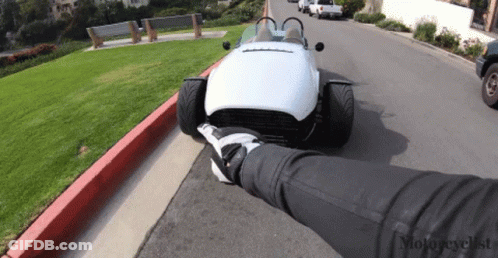 White Sports Car Parked By Grassy Hill GIF