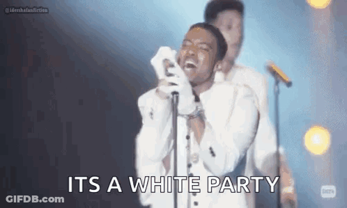 White Suited Singer At Mic With Man Behind GIF