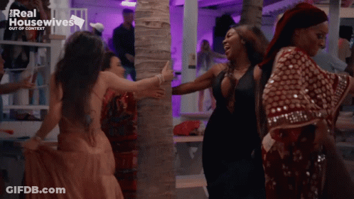 White Tank Top Woman Walking With Red Dress Woman GIF