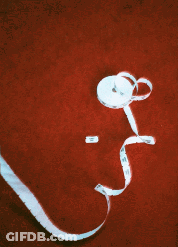 White Tape Measure Labeled A On Red Surface GIF