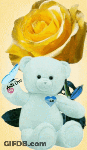 White Teddy Bear With Blue Heart Beside Yellow Rose GIF