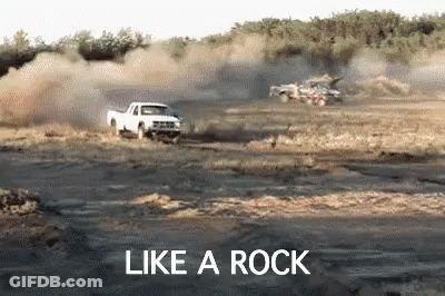 White Truck Driving Down Dirt Road Like A Rock GIF