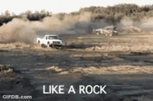 White Truck Driving Down Dirt Road Like A Rock GIF