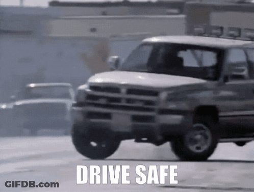 White Truck Driving Down Street Saying Drive Safe GIF