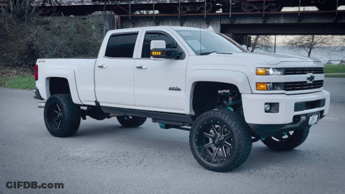 White Truck Parked In Front Of Bridge With Train GIF