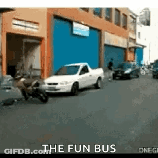 White Truck Parked In Front Of The Fun Bus GIF
