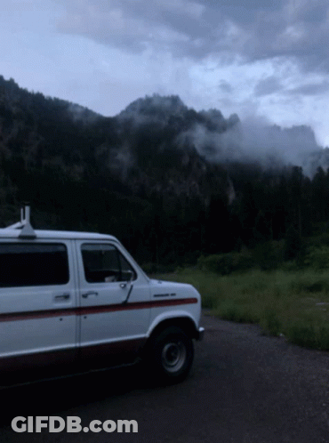 White Van Parked In Front Of Mountain GIF