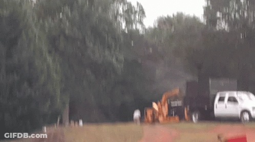 White Van Parked Next To Tractor GIF