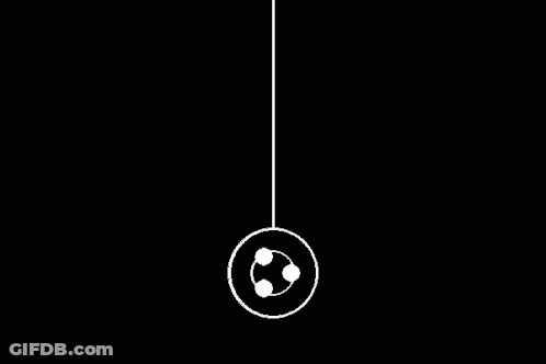 White Yo-Yo Hanging From String In Dark GIF