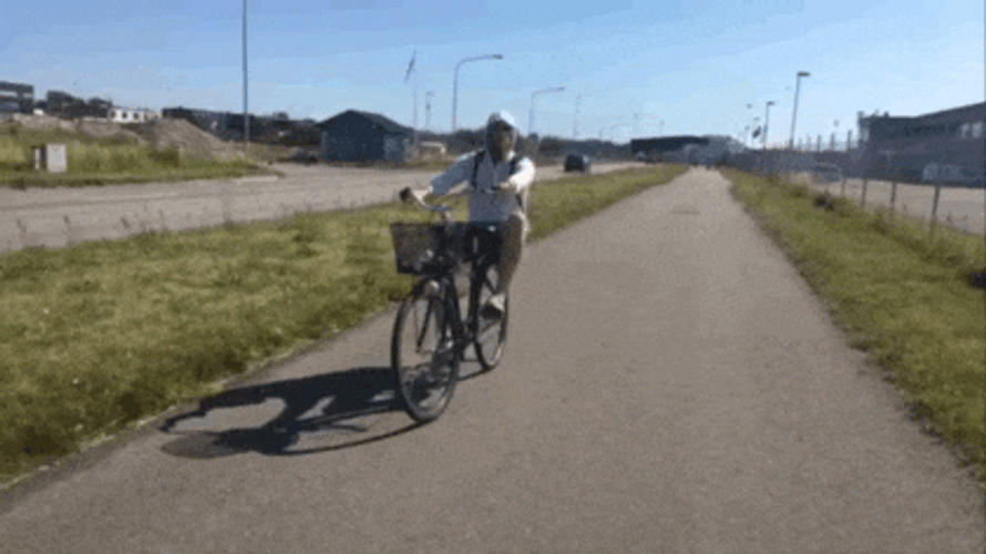 Widely Riding Bike By The Streets GIF