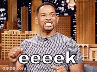 Will Smith Is Making A Funny Face While Sitting In Front Of A Microphone And Pointing At The Camera . GIF