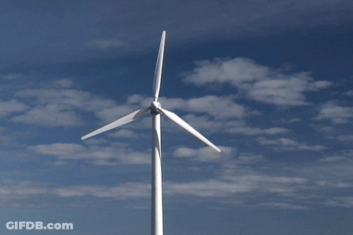 Wind Turbine Against Cloudy Blue Sky GIF