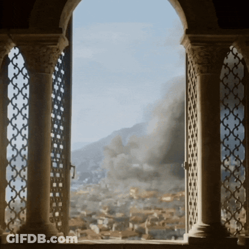 Window View Of City With Smoke From Mountains GIF