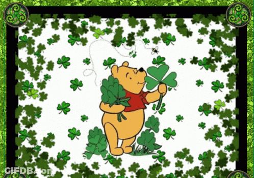 Winnie The Pooh Holding Four Leaf Clover Surrounded By Clovers GIF