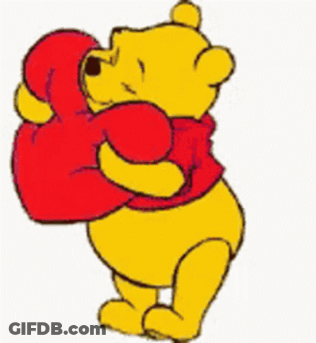 Winnie The Pooh Is Holding A Red Heart In His Mouth GIF