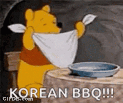 Winnie The Pooh Is Sitting At A Table Holding A Towel Over His Head And Saying `` Korean Bbq '' . GIF