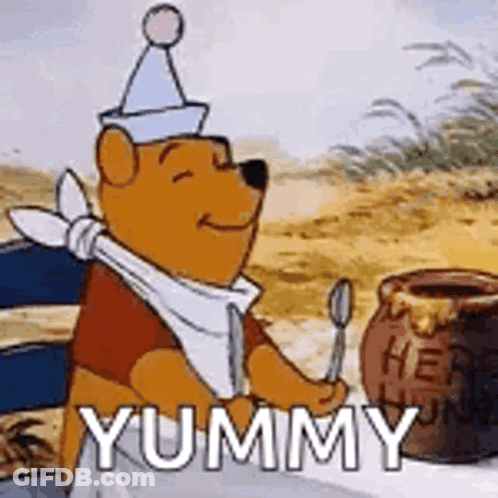 Winnie The Pooh Is Sitting At A Table With A Jar Of Honey And A Spoon In His Hand . GIF