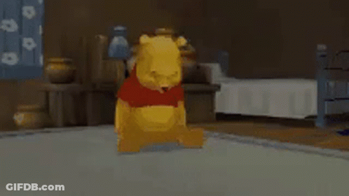 Winnie The Pooh Is Sitting On The Floor In A Bedroom . GIF
