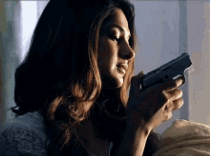 Wishful Woman Holding A Small Gun GIF