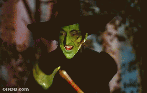Witch With Green Face Paint And Black Hat GIF