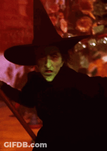 Witch With Green Face Paint And Black Hat GIF