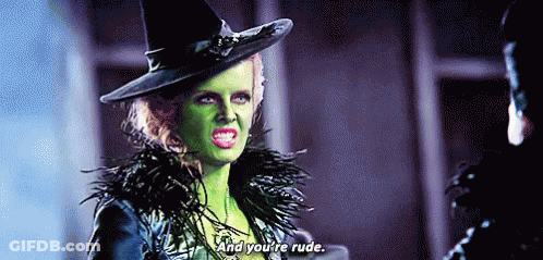 Witch With Green Face Paint Talking To Man In Hat GIF