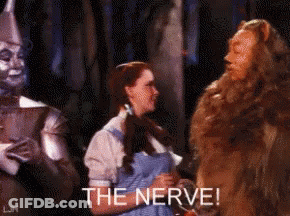 Wizard Of Oz Woman Sitting Next To Lion The Nerve GIF