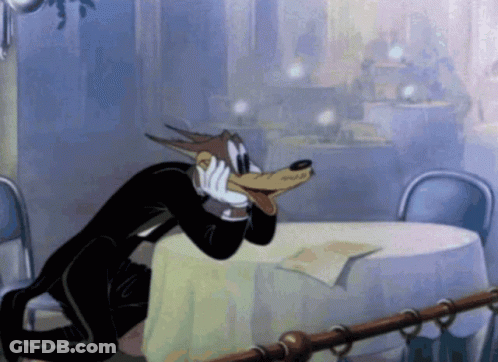 Wolf In Tuxedo Sitting At Table GIF
