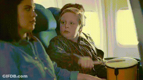Woman And Boy Playing Drums On Airplane GIF