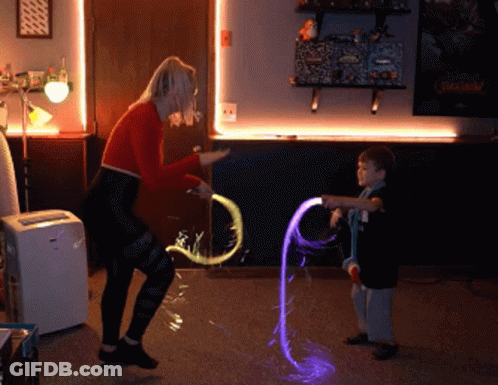 Woman And Boy Playing With Glow Toys GIF