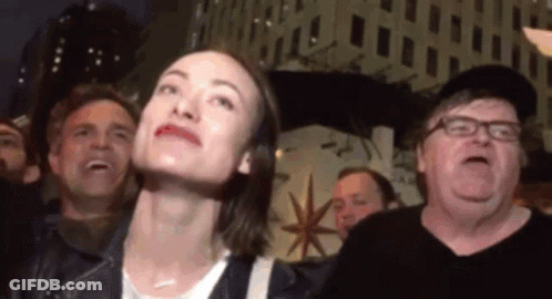 Woman And Crowd Looking Up At Sky GIF