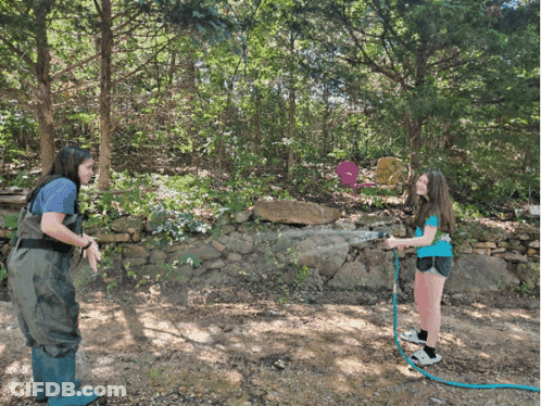 Woman And Girl Playing With Hose GIF