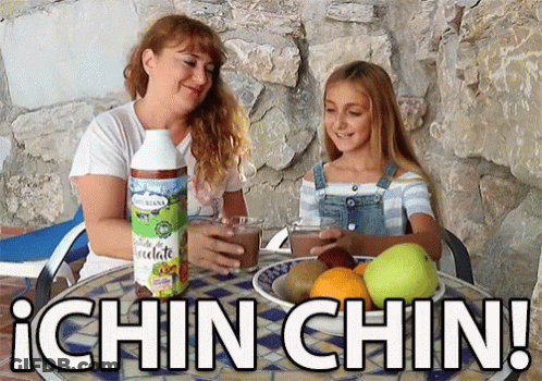 Woman And Girl Sitting At Table With Ichin Chin Bottle GIF