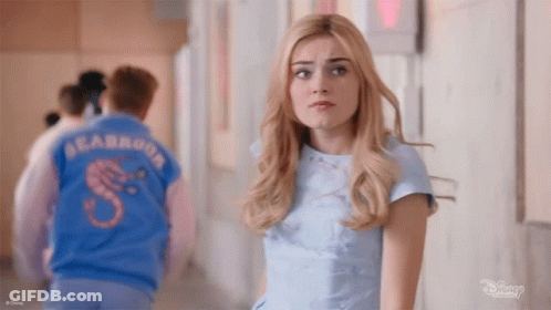 Woman And Man In Blue Shirts In Hallway GIF