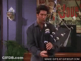 Woman And Man Sitting On Couch Looking At Camera GIF