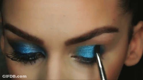 Woman Applying Blue Eye Shadow With Brush GIF