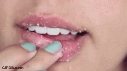 Woman Applying Lip Scrub With Finger GIF