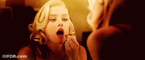 Woman Applying Lipstick In Mirror GIF