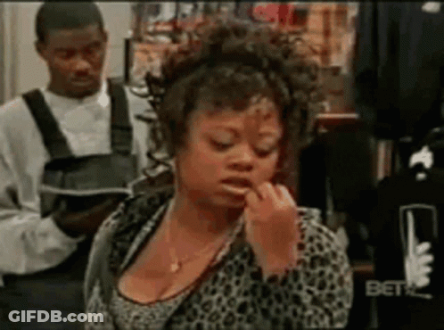 Woman Applying Lipstick In Store While Man Holds Book GIF