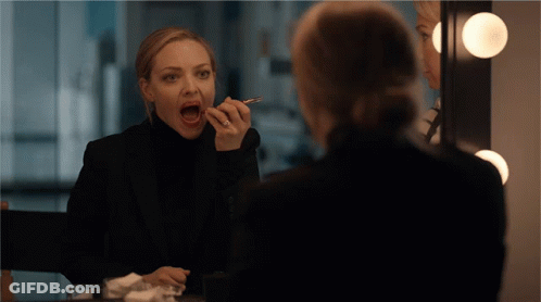 Woman Applying Makeup With Mouth Open GIF