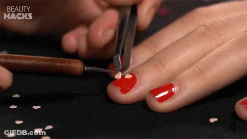 Woman Applying Red Nail Polish GIF