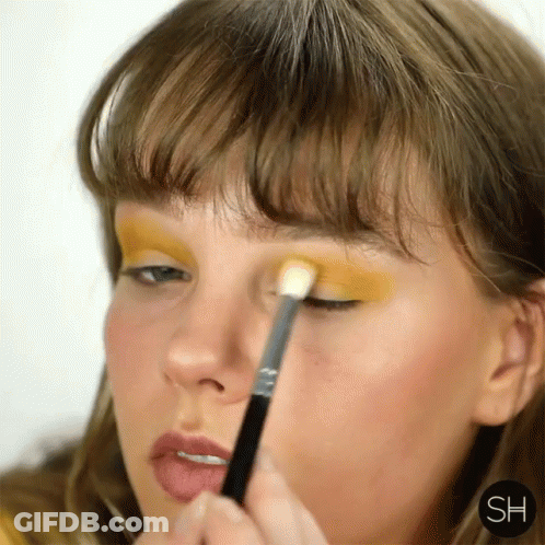 Woman Applying Yellow Eyeshadow With Brush GIF