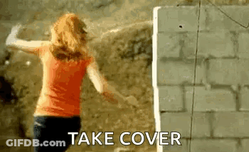 Woman Arms Outstretched Brick Wall Take Cover GIF