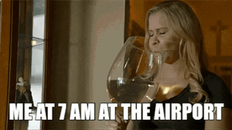 Woman At Airport Drinking In Big Glass GIF