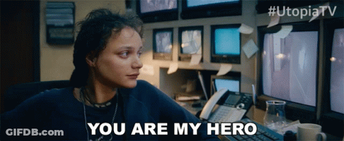 Woman At Desk Saying You Are My Hero In Front Of Monitors GIF